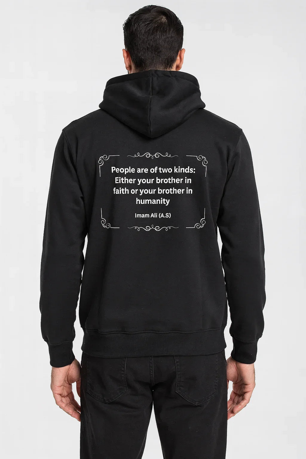 Man wearing black hoodie with faith and humanity quote on back, casual streetwear
